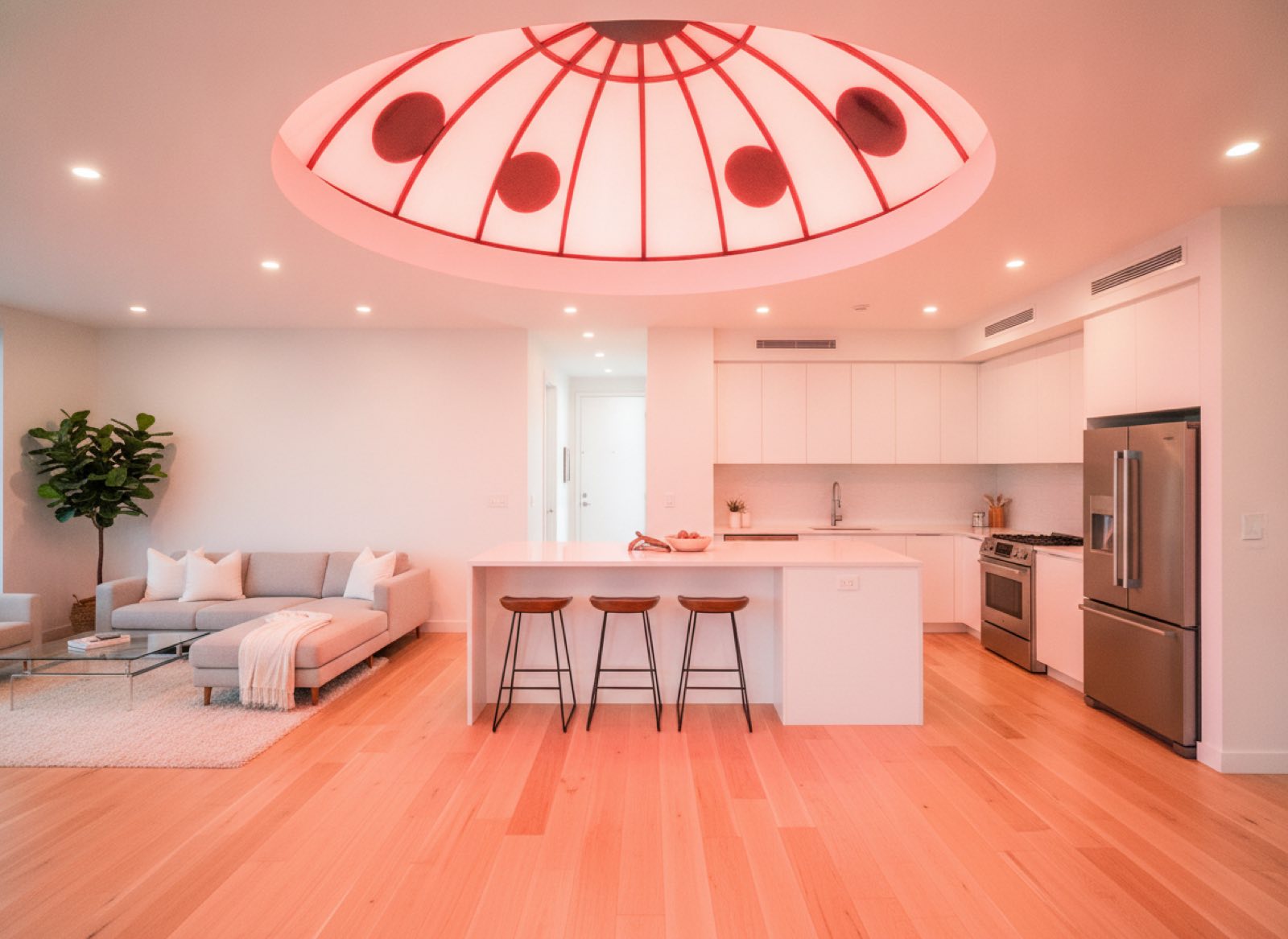 One-bedroom living room lit by a domed red skylight with black markings, like a wing case overhead